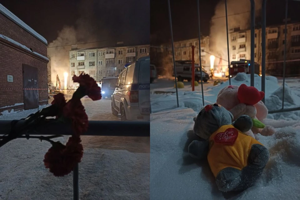 Люди несут цветы и игрушки к обрушившемуся дому.