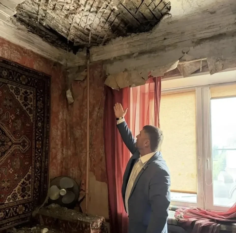 Владислав Атмахов помогает жительнице разрушающейся квартиры. ФОТО: НРО ЛДПР