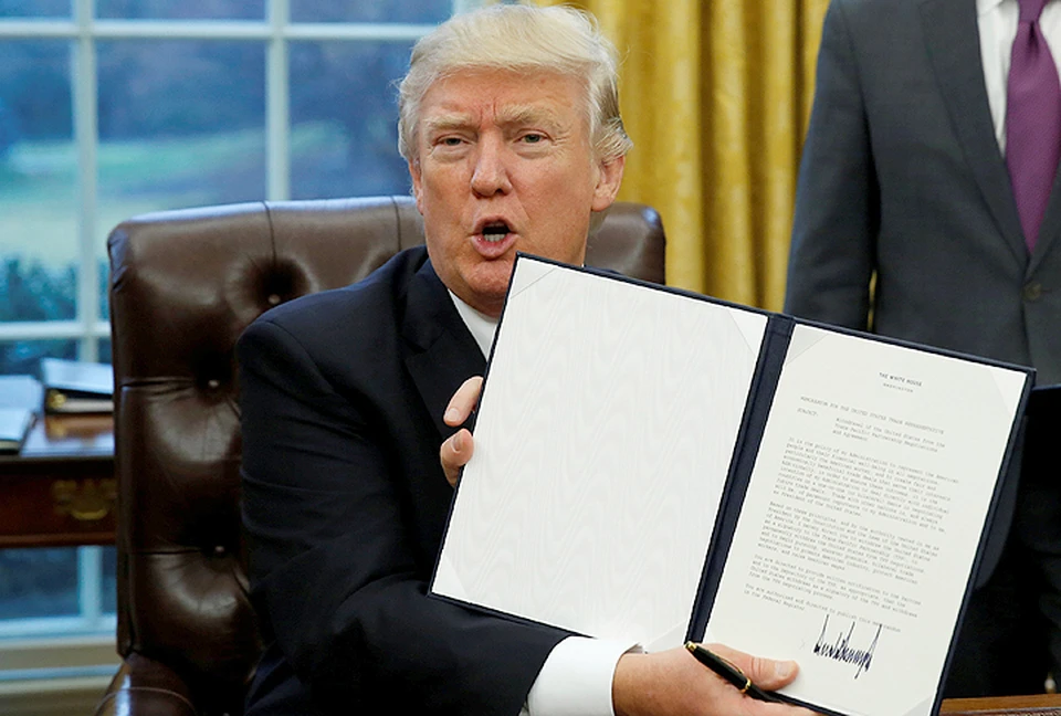 Дональд Трамп демонстрирует подписанный им документ о выходе США из Транстихоокеанского партнерства.